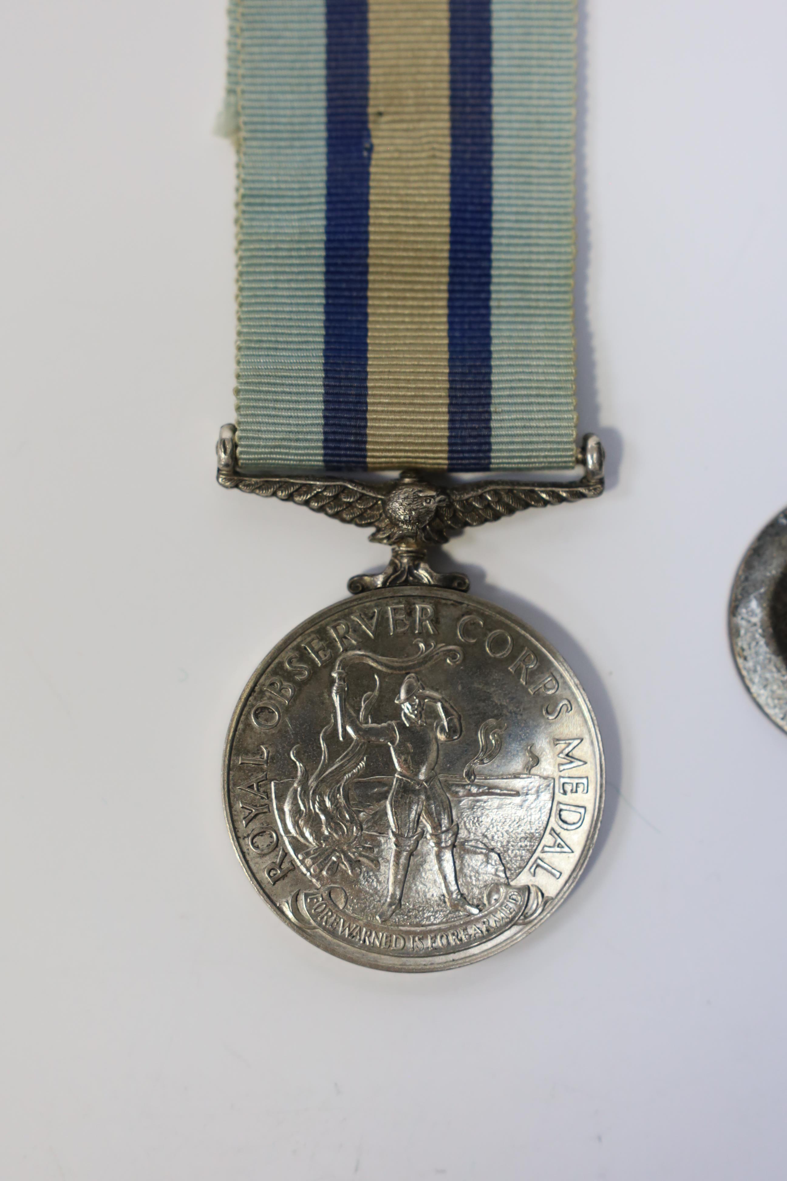 An ERII (B) Royal Observer Corps medal to Observer W.Cook with a lapel badge. Condition - fair.